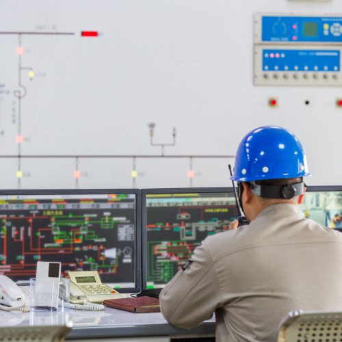 workers in control room of a factory.